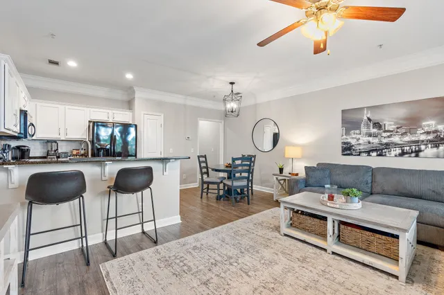 a living room with furniture and a chandelier