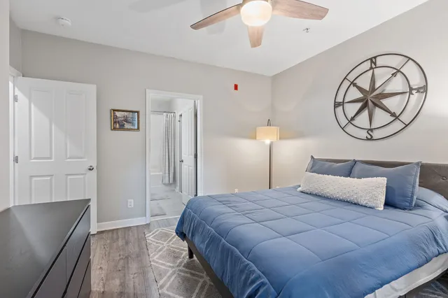 a bedroom with a large bed and a chandelier