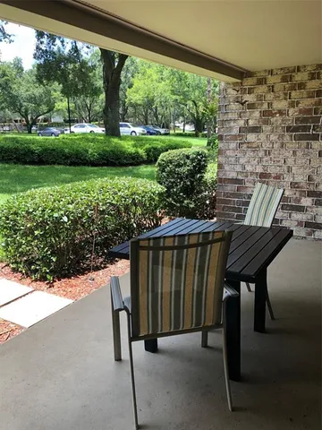 a view of balcony with wooden floor and outdoor seating