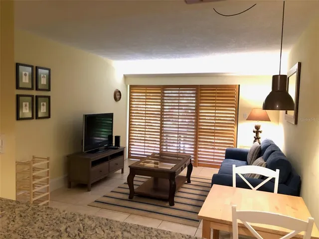 a livingroom with furniture and a flat screen tv