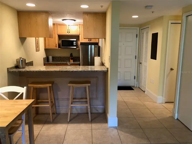 a kitchen with kitchen island granite countertop a sink and counter space