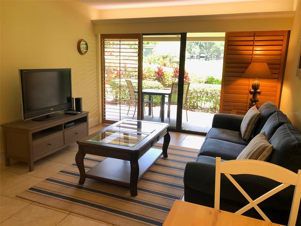 36750 US Highway 19 North, Unit 23107 Palm Harbor, FL 34683 - Photo 3 of 16 a living room with furniture and a flat screen tv