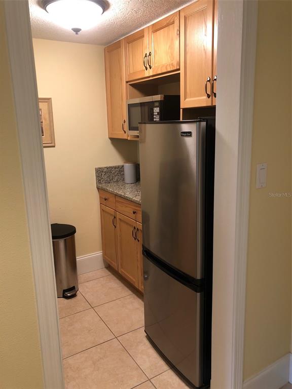 36750 US Highway 19 North, Unit 23107 Palm Harbor, FL 34683 - Photo 6 of 16 a kitchen with stainless steel appliances a refrigerator and cabinets