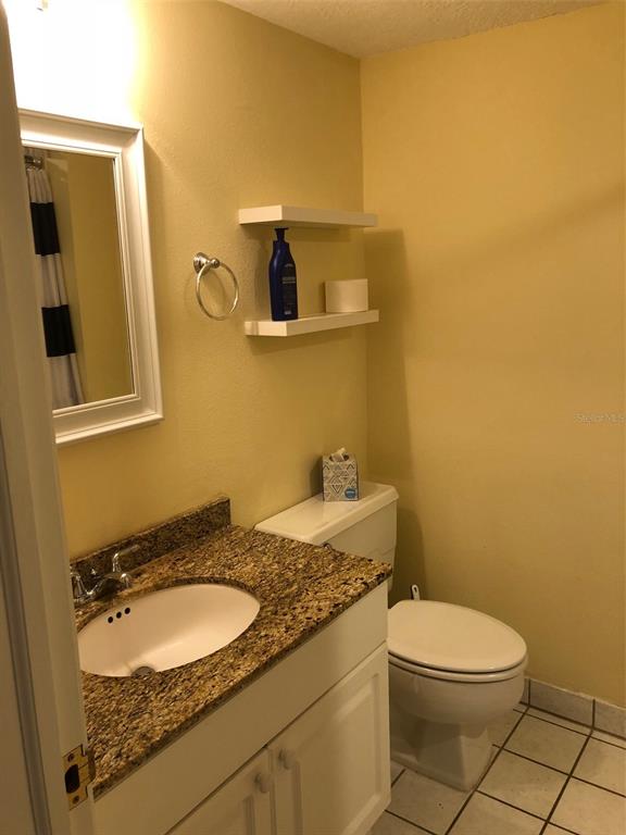 36750 US Highway 19 North, Unit 23107 Palm Harbor, FL 34683 - Photo 10 of 16 a bathroom with a granite countertop sink and a mirror