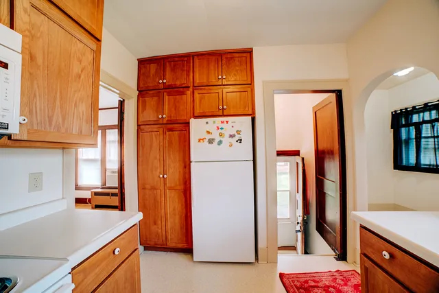 a kitchen with stainless steel appliances granite countertop a refrigerator and a sink