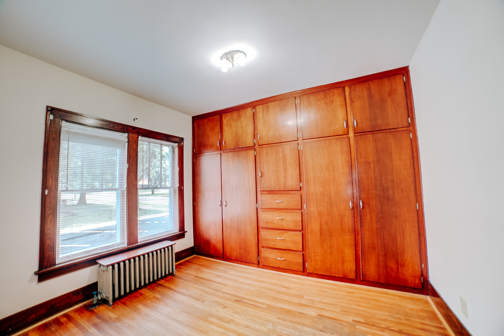 317 South 4th Street Watseka, IL 60970 - Photo 25 of 40 an empty room with wooden floor and windows