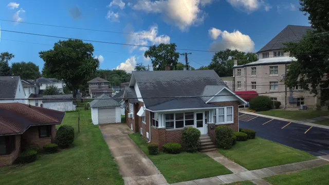 a aerial view of a house with a yard table and chairs