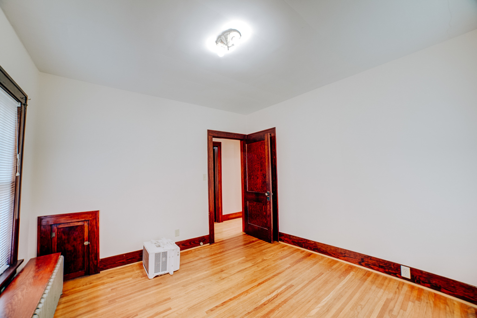 317 South 4th Street Watseka, IL 60970 - Photo 31 of 40 a view of an empty room with wooden floor and a window