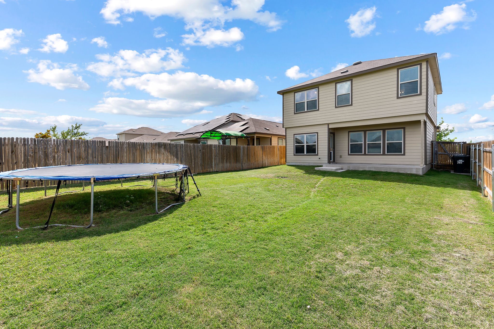 576 Greatest Gift Way Jarrell, TX 76537 - Photo 31 of 37 A fenced backyard offers ample green space for leisure activities.