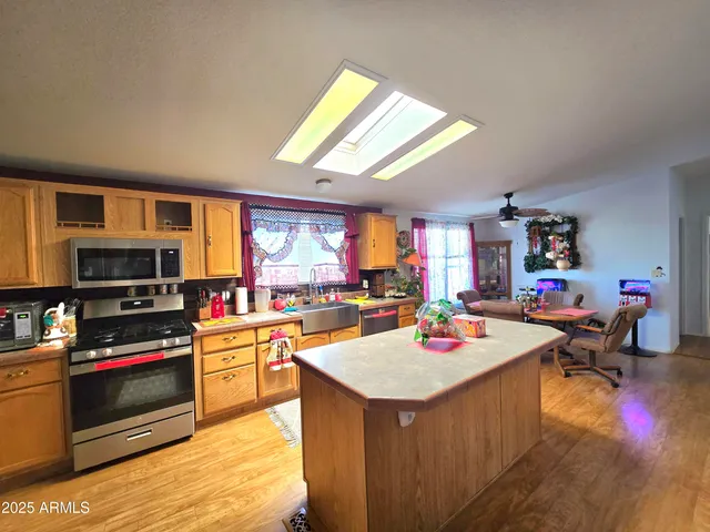 a dining room with a table chairs and a kitchen
