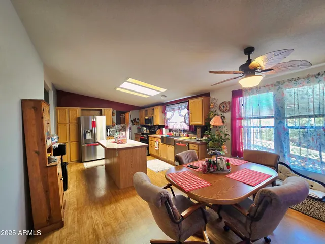 a living room with furniture a flat screen tv and a large window