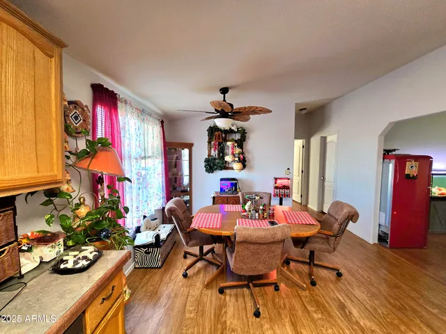 a view of a dining room with furniture a chandelier and wooden floor