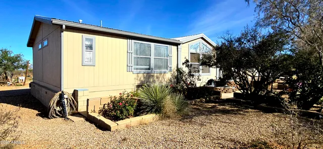 a view of a house with backyard and sitting area