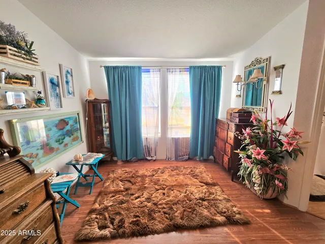 a bedroom with furniture and a large window