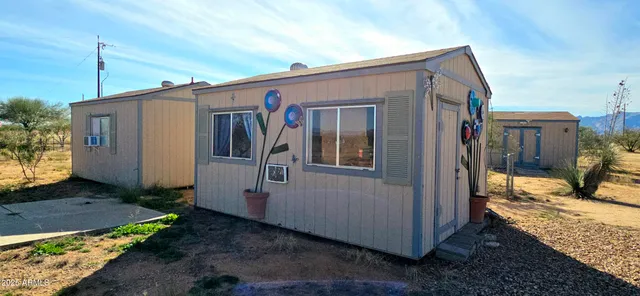 a view of a house with a backyard