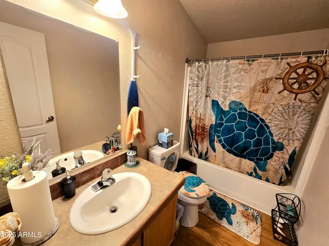 a bathroom with a sink and mirror with toilet