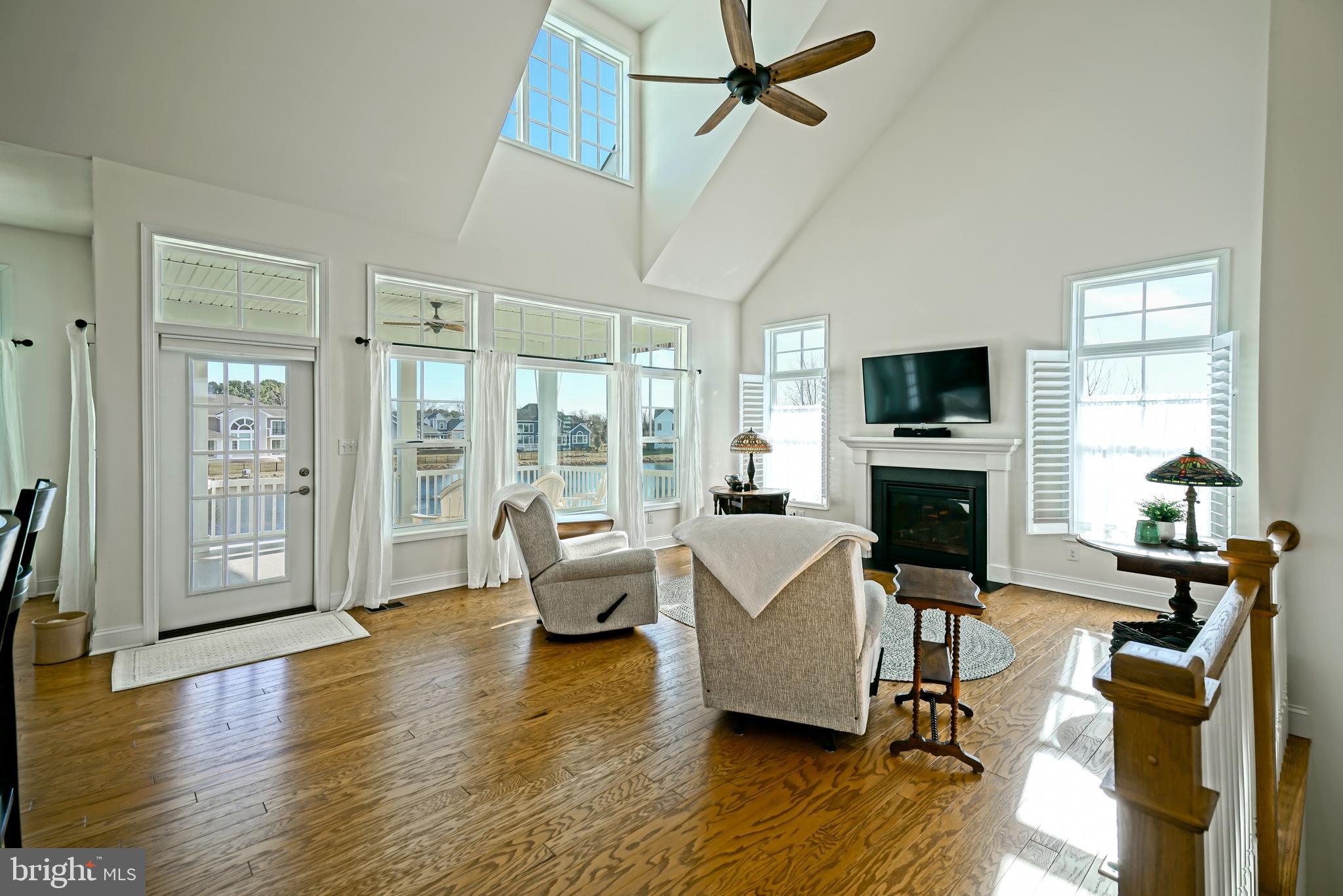 36903 Crossrail Way Lewes, DE 19958 - Photo 13 of 120 a living room with fireplace furniture and a flat screen tv