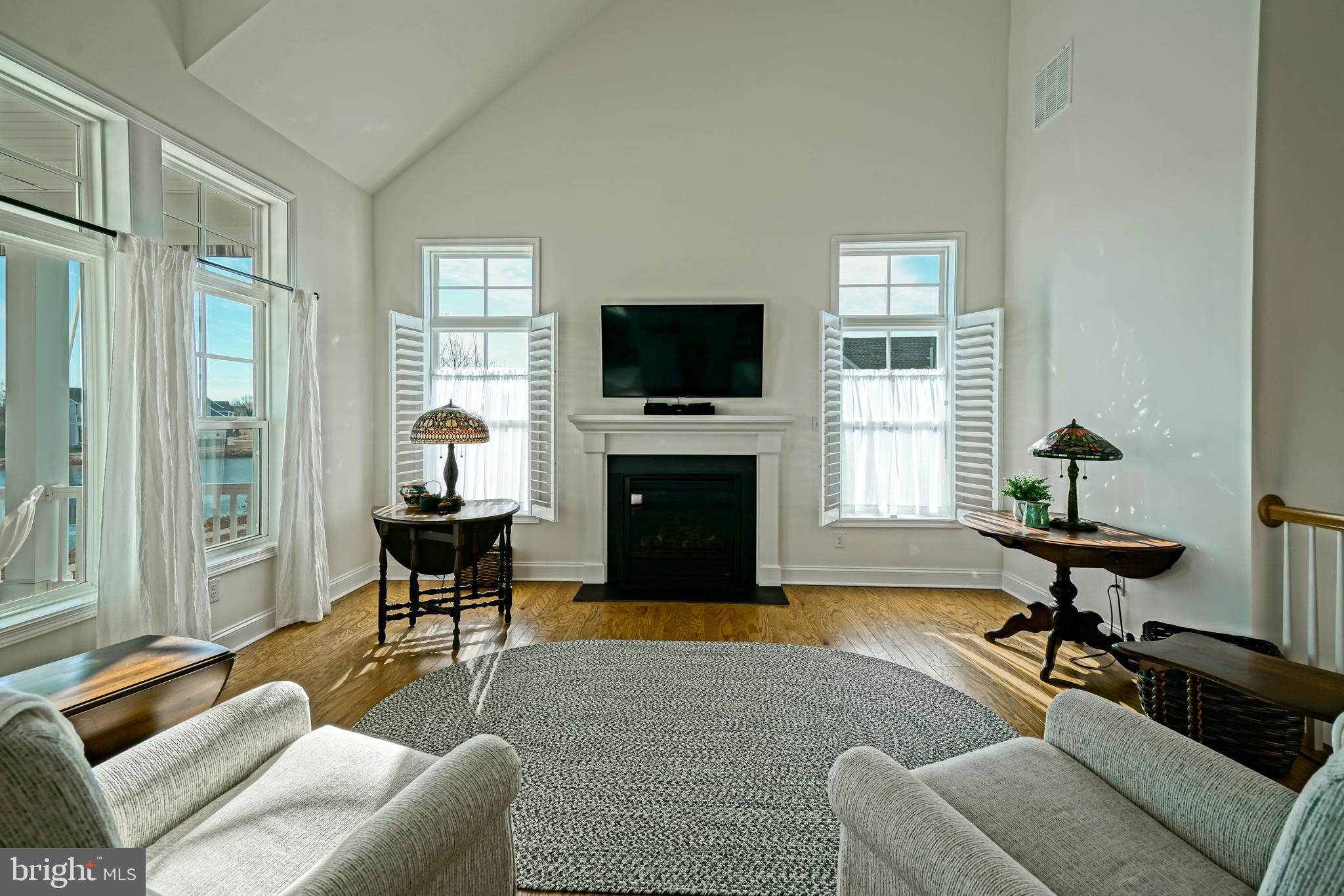 36903 Crossrail Way Lewes, DE 19958 - Photo 15 of 120 a living room with furniture a fireplace and a flat screen tv