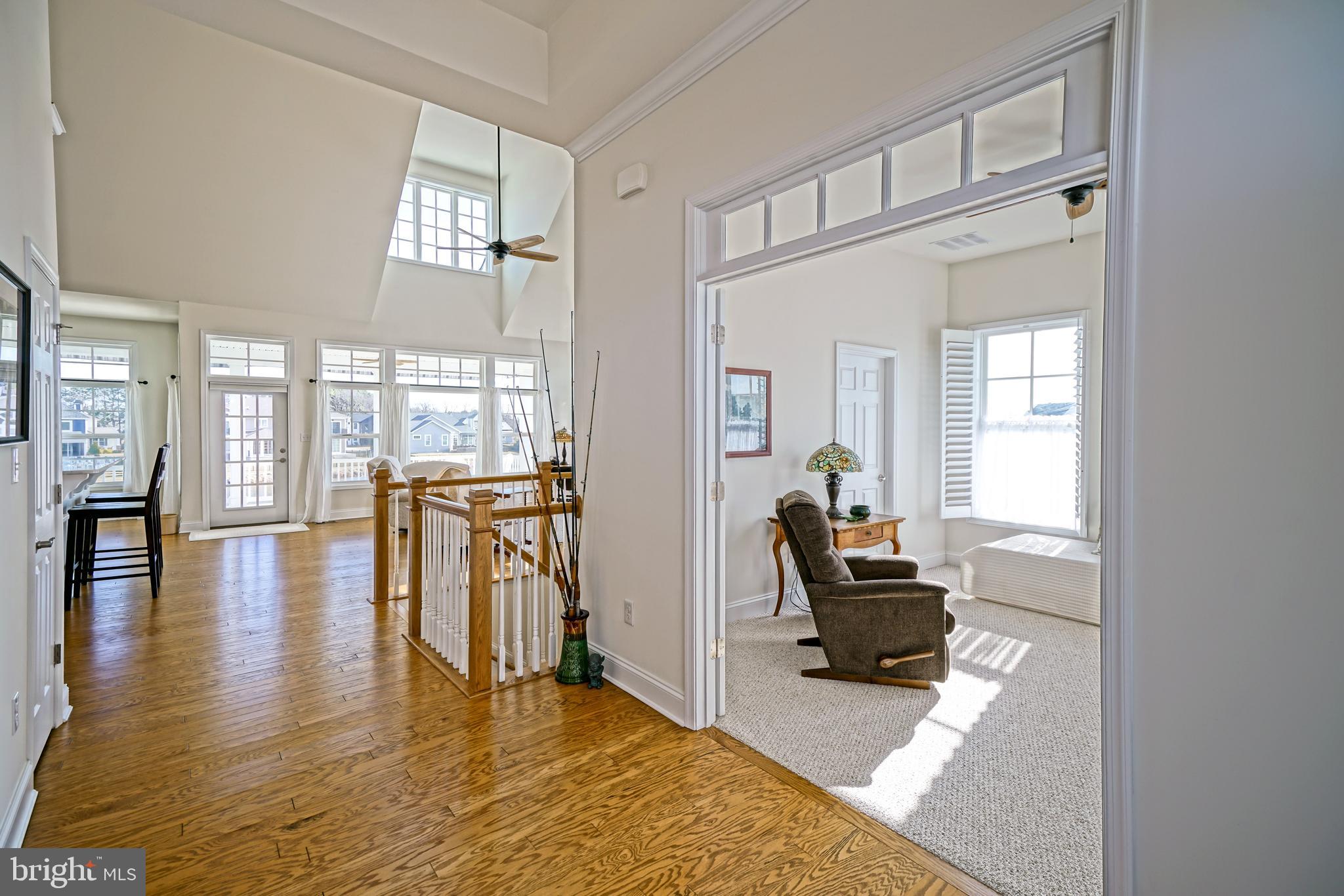 36903 Crossrail Way Lewes, DE 19958 - Photo 5 of 120 a living room with furniture and a large mirror next to a window