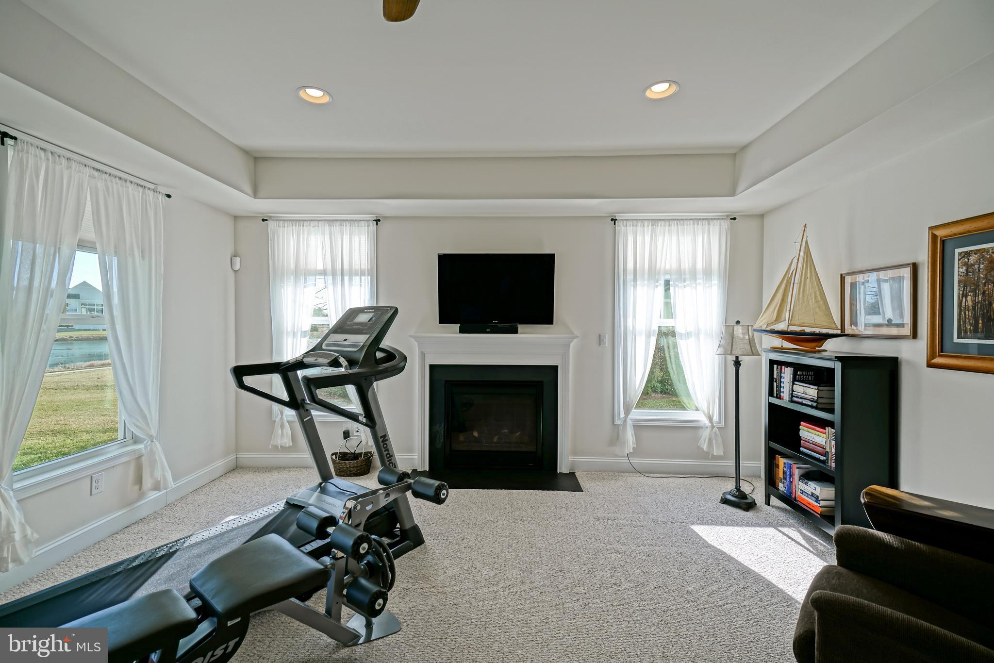 36903 Crossrail Way Lewes, DE 19958 - Photo 64 of 120 a living room with furniture a window and a flat screen tv