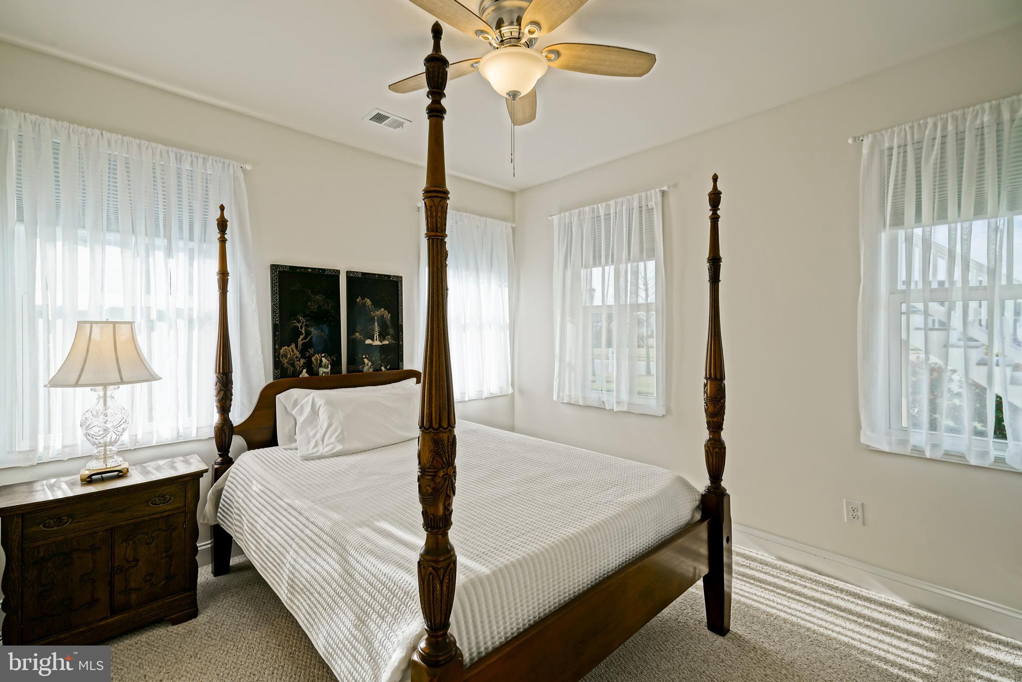 36903 Crossrail Way Lewes, DE 19958 - Photo 68 of 120 a bedroom with a bed and a chandelier