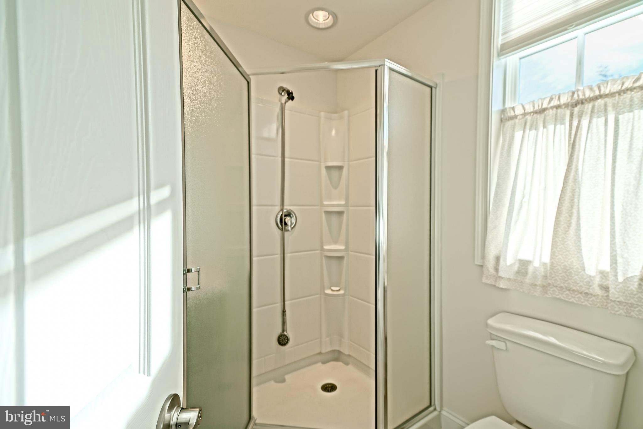 36903 Crossrail Way Lewes, DE 19958 - Photo 71 of 120 a bathroom with a shower a toilet and a window