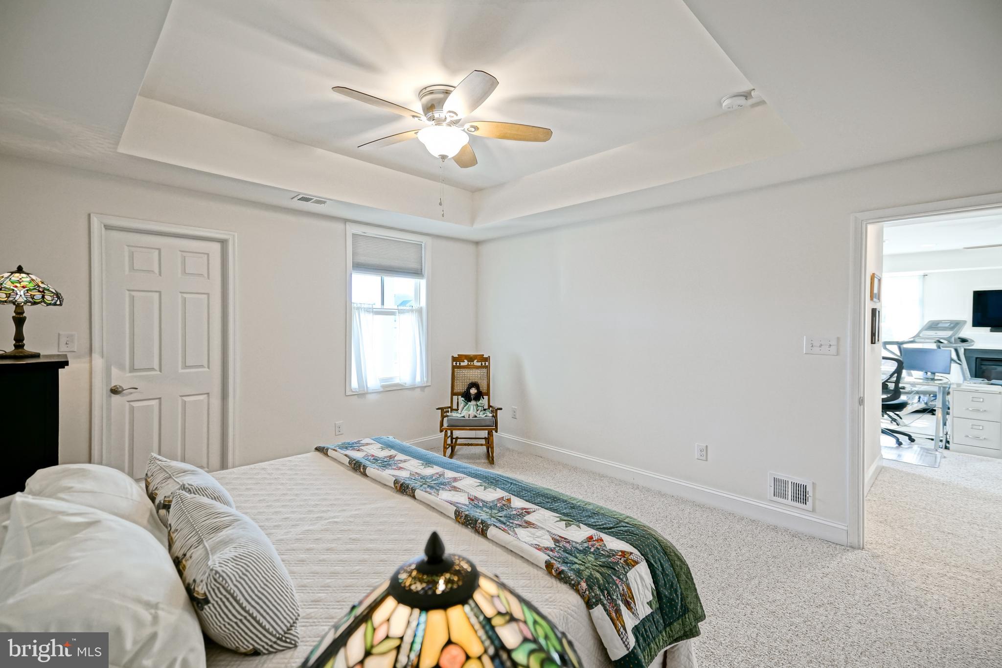 36903 Crossrail Way Lewes, DE 19958 - Photo 76 of 120 a bedroom with a bed and a chandelier