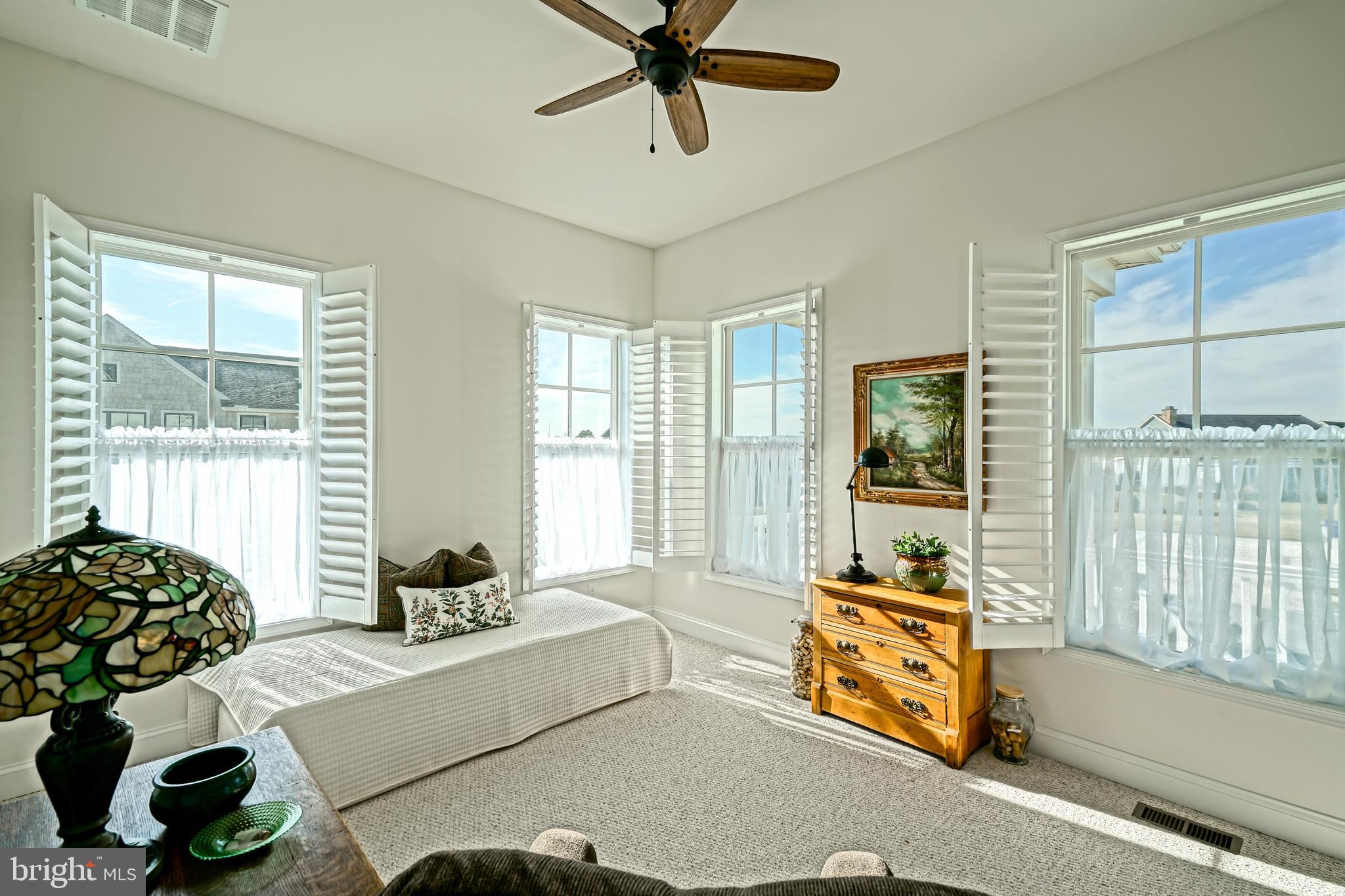 36903 Crossrail Way Lewes, DE 19958 - Photo 9 of 120 a living room with furniture and floor to ceiling windows