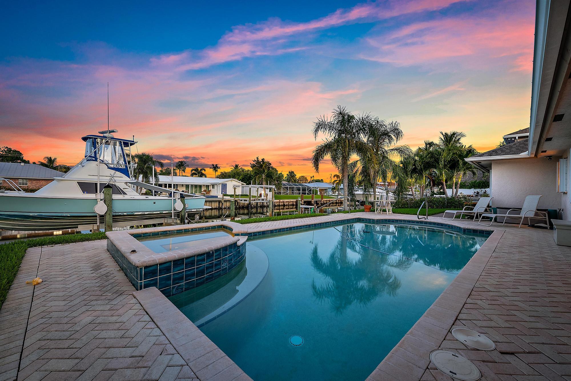 925 Dolphin Drive Jupiter, FL 33458 - Photo 1 of 37 a view of a swimming pool with chairs