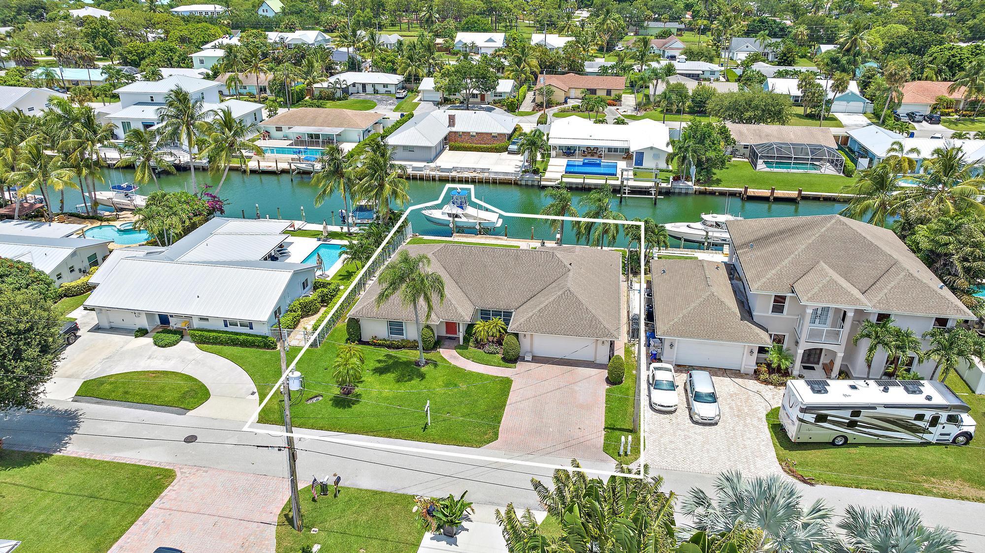 925 Dolphin Drive Jupiter, FL 33458 - Photo 33 of 37 an aerial view of residential houses with outdoor space and parking