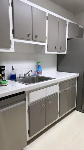 a kitchen with stainless steel appliances granite countertop a sink a stove and dishwasher with cabinets