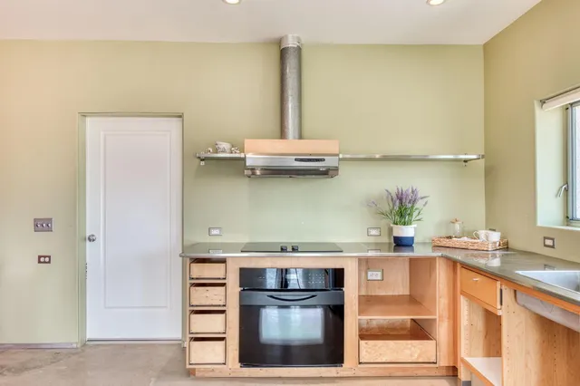 a kitchen with stainless steel appliances a sink and a stove