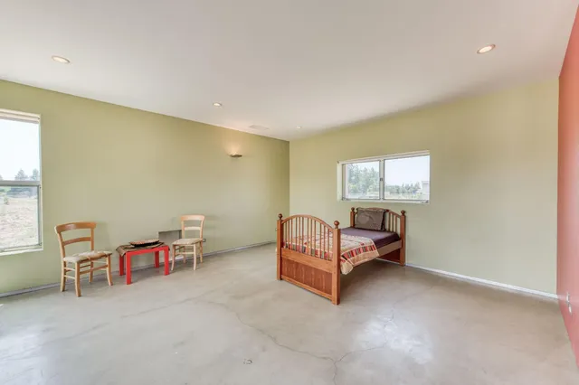 a view of a livingroom with furniture and a window