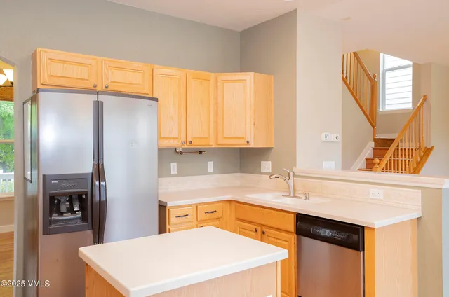 a kitchen with stainless steel appliances a refrigerator sink and cabinets