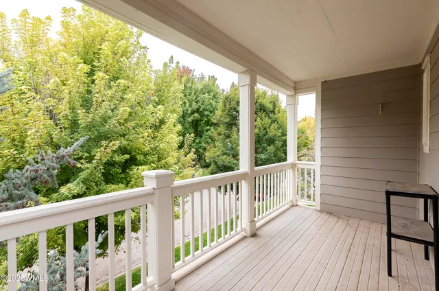 a view of a balcony with wooden floor