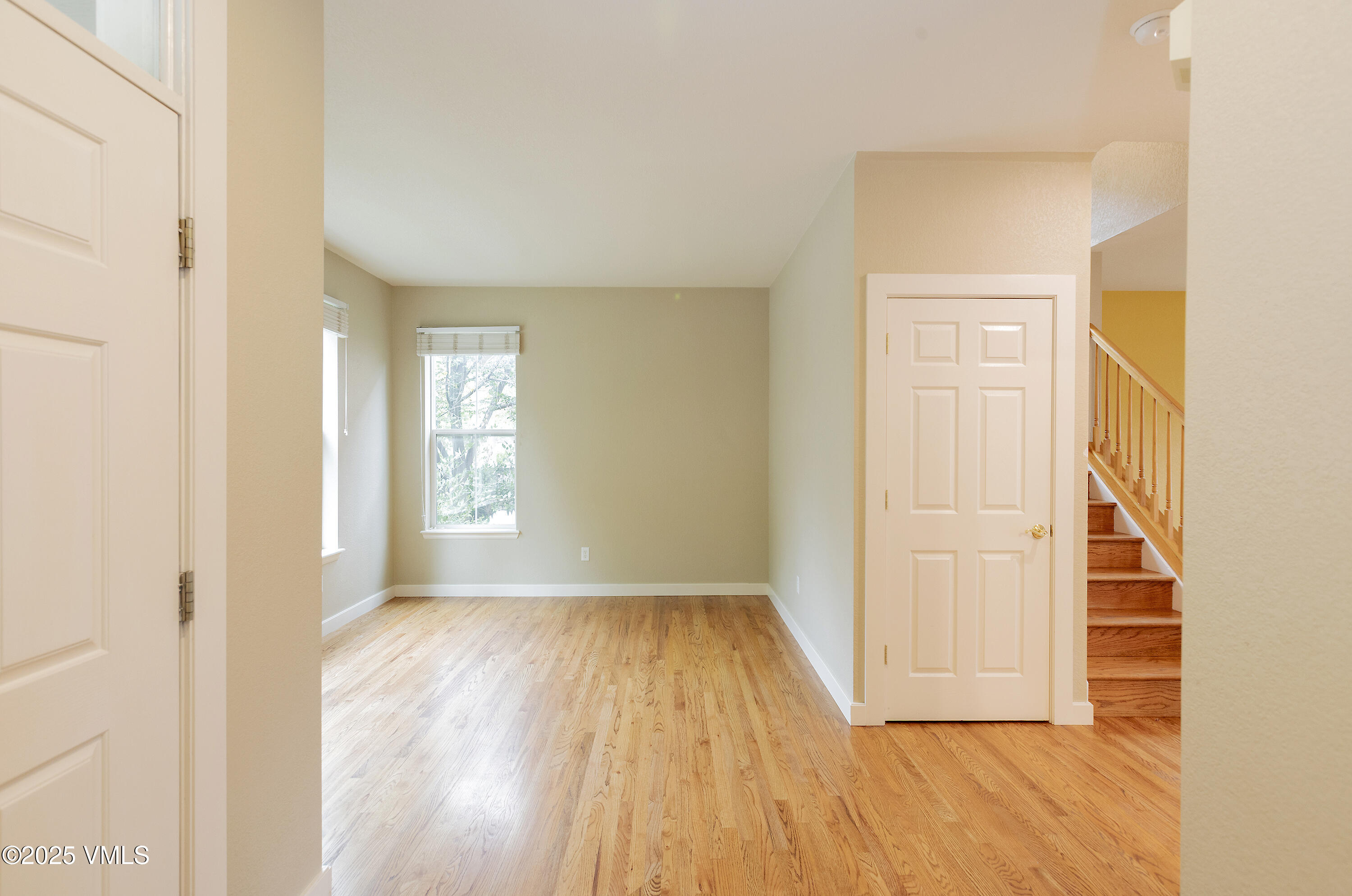 95 Eagle Ranch Road Eagle, CO 81631 - Photo 4 of 31 a view of an empty room with wooden floor and a window