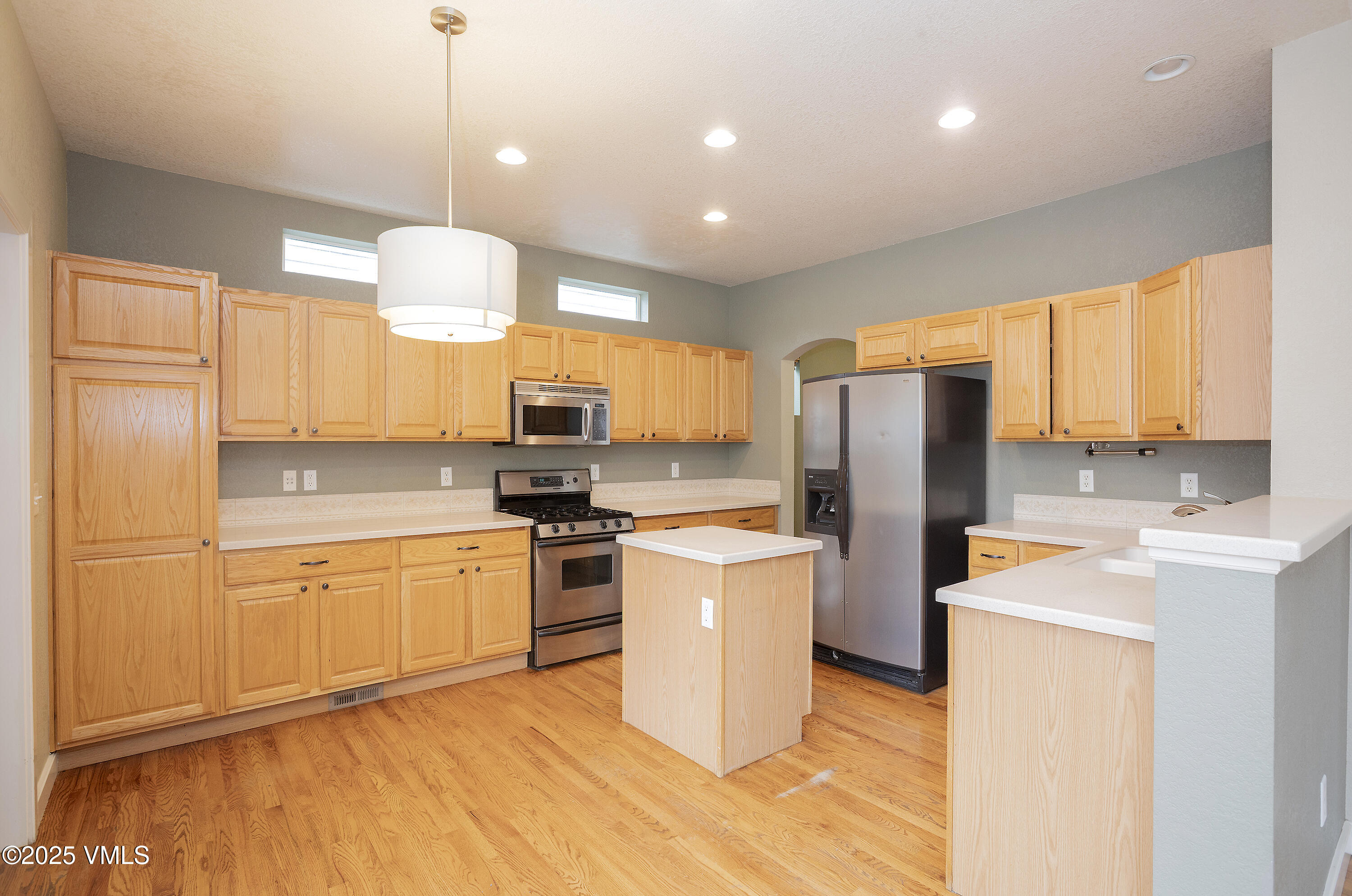 95 Eagle Ranch Road Eagle, CO 81631 - Photo 9 of 31 a kitchen with stainless steel appliances granite countertop a refrigerator a stove top oven a sink dishwasher and white cabinets with wooden floor