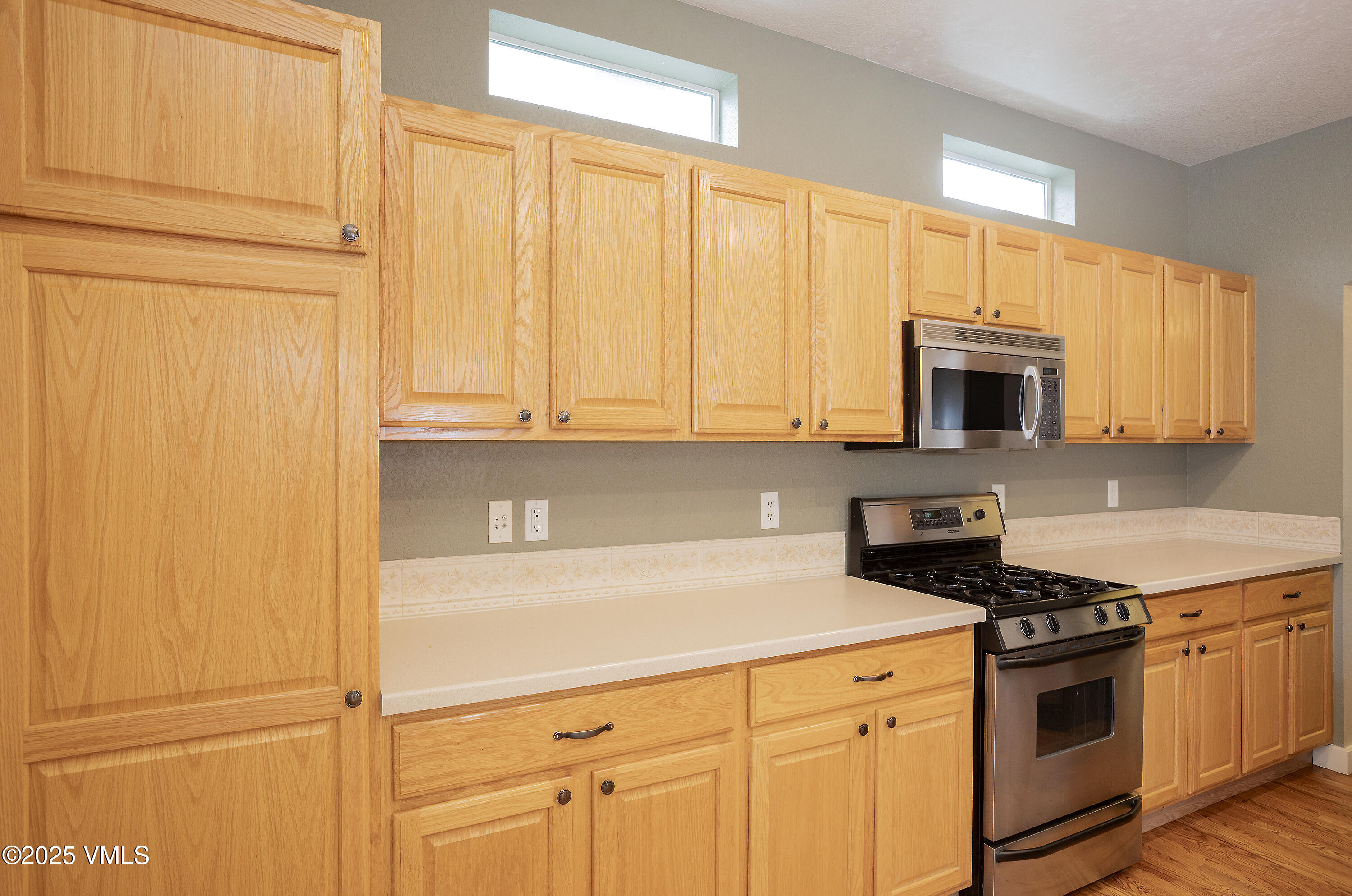 95 Eagle Ranch Road Eagle, CO 81631 - Photo 10 of 31 a kitchen with stainless steel appliances a stove a microwave and cabinets