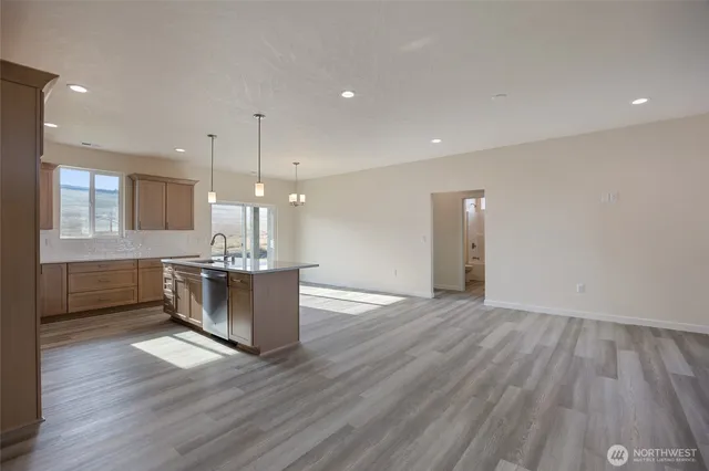 a view of a room with wooden floor and a hallway