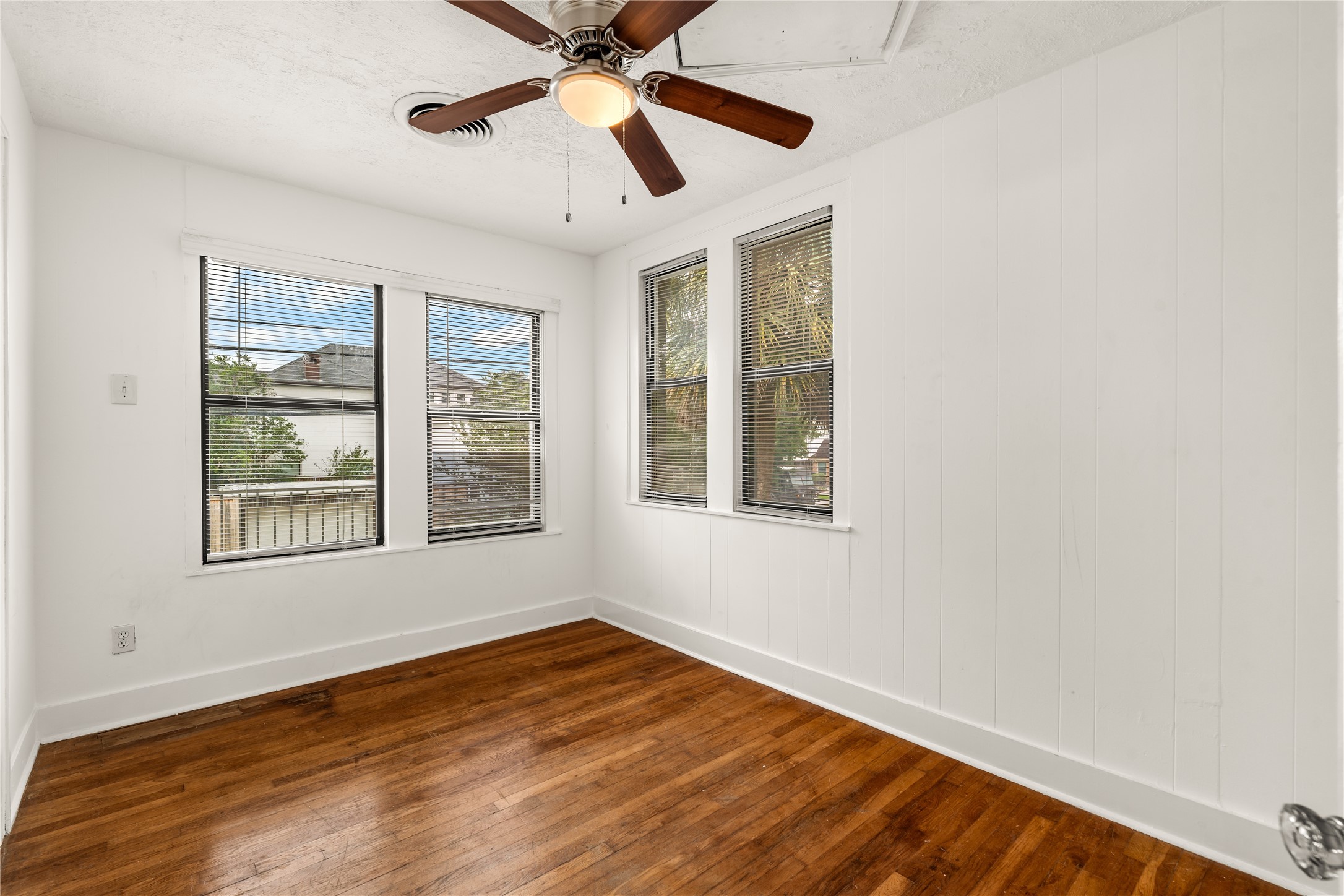 2202 West Main Street Houston, TX 77098 - Photo 27 of 32 a view of an empty room with wooden floor and a window