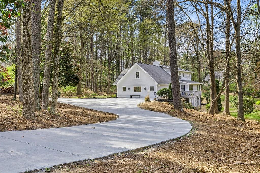 12 Providence Way Milton, GA 30004 - Photo 32 of 56 a view of a house with trees in the background