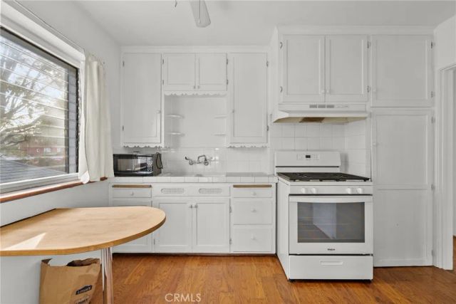 a kitchen with appliances cabinets and a sink