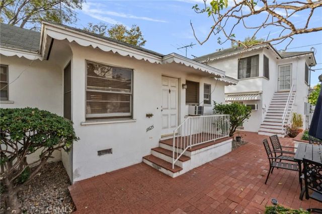 a view of backyard with a deck and furniture