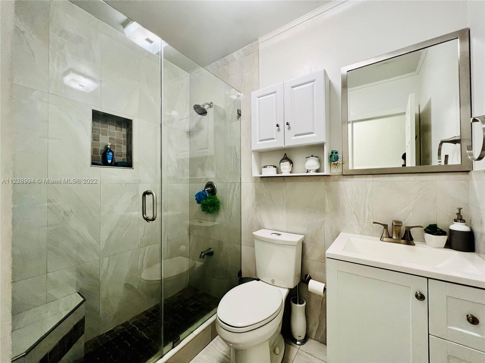 599 West 46th Place Hialeah, FL 33012 - Photo 11 of 25 a bathroom with a toilet sink and shower