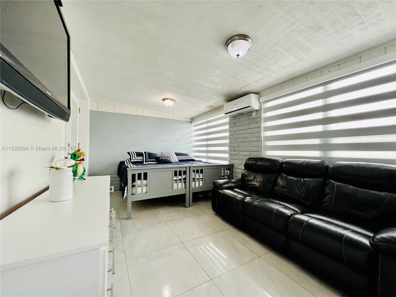 599 West 46th Place Hialeah, FL 33012 - Photo 12 of 25 a living room with furniture and a window