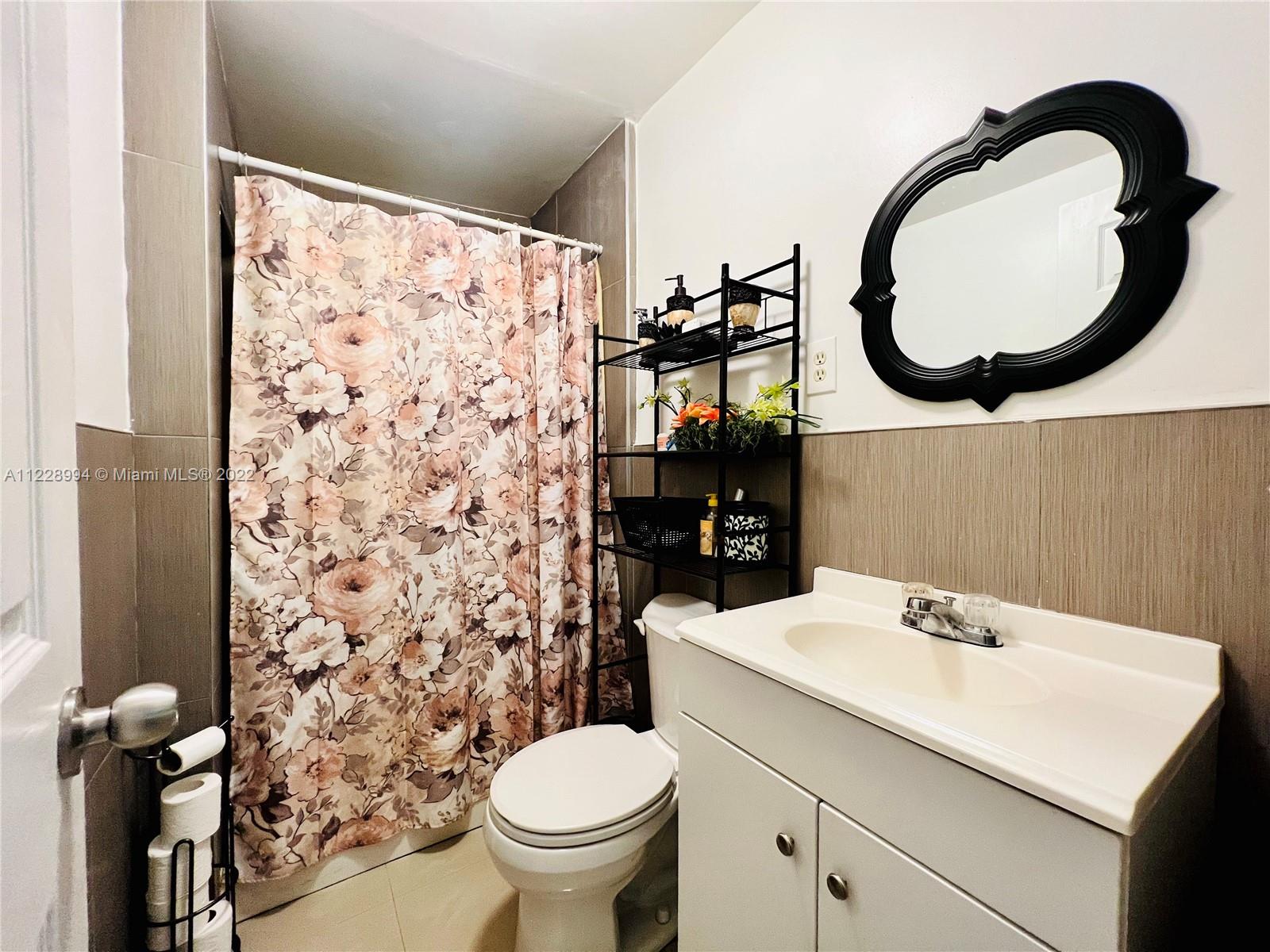 599 West 46th Place Hialeah, FL 33012 - Photo 16 of 25 a bathroom with a sink and a mirror