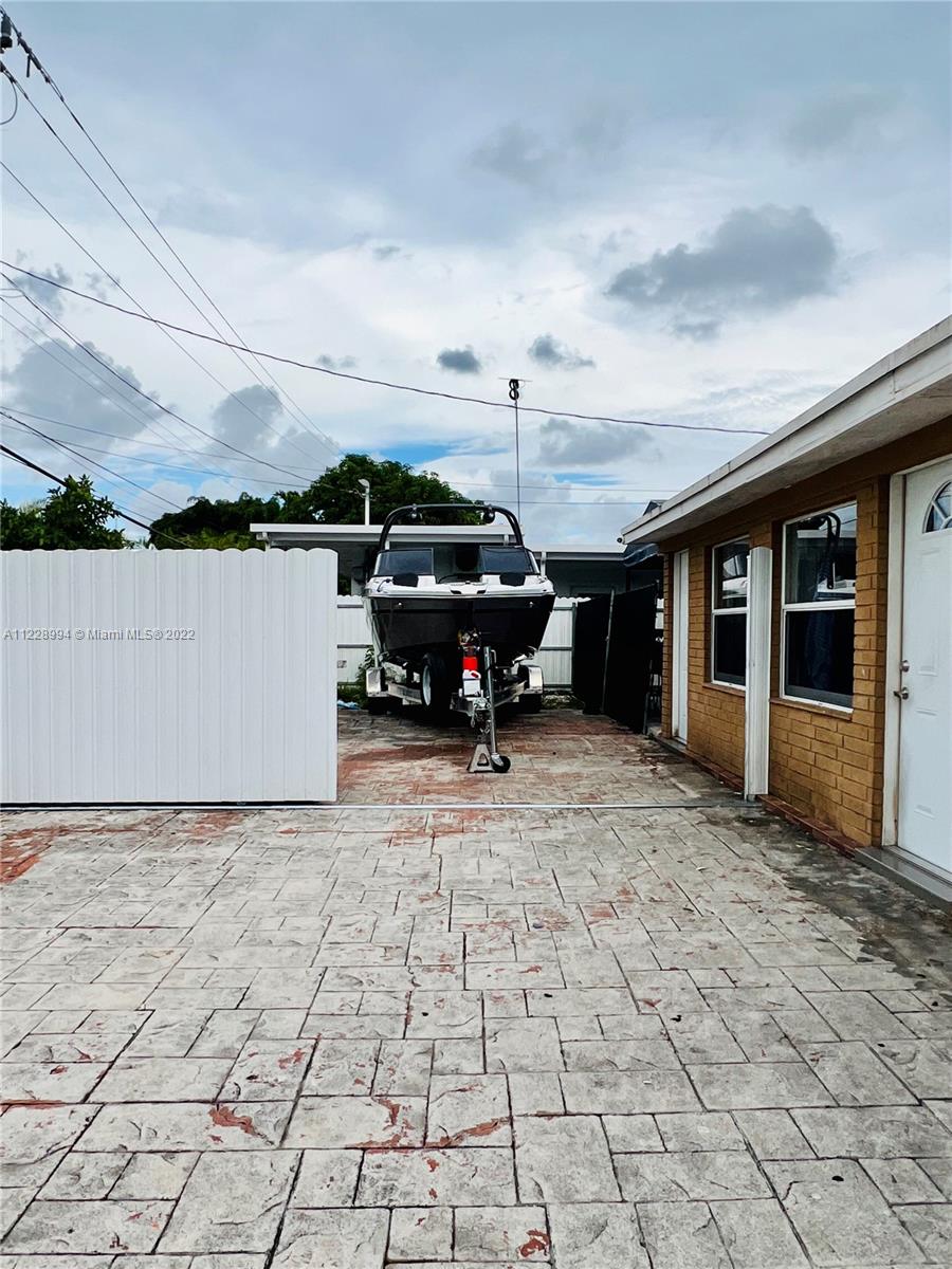 599 West 46th Place Hialeah, FL 33012 - Photo 19 of 25 a car parked in front of house