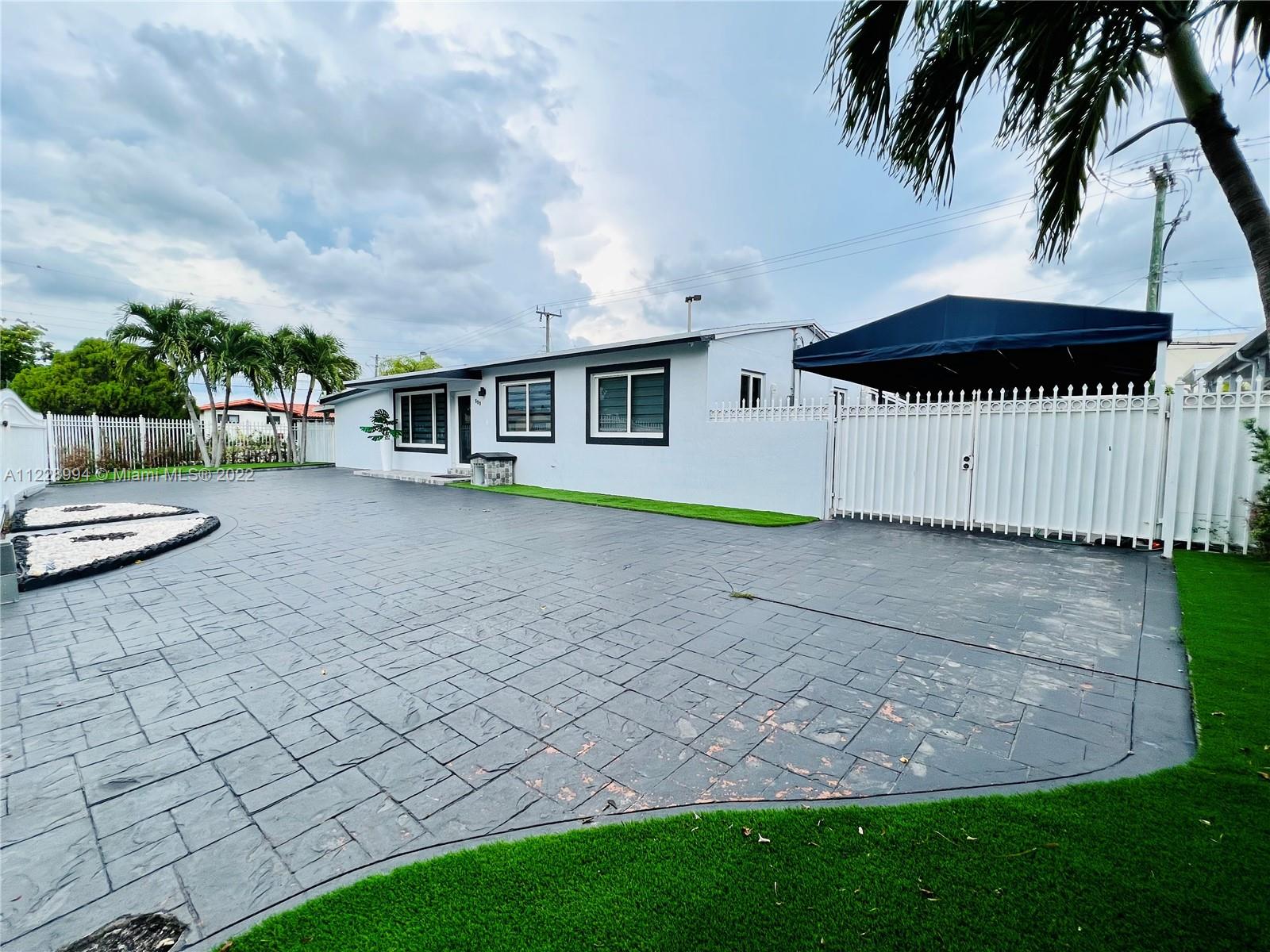 599 West 46th Place Hialeah, FL 33012 - Photo 2 of 25 a view of a house with backyard and sitting area