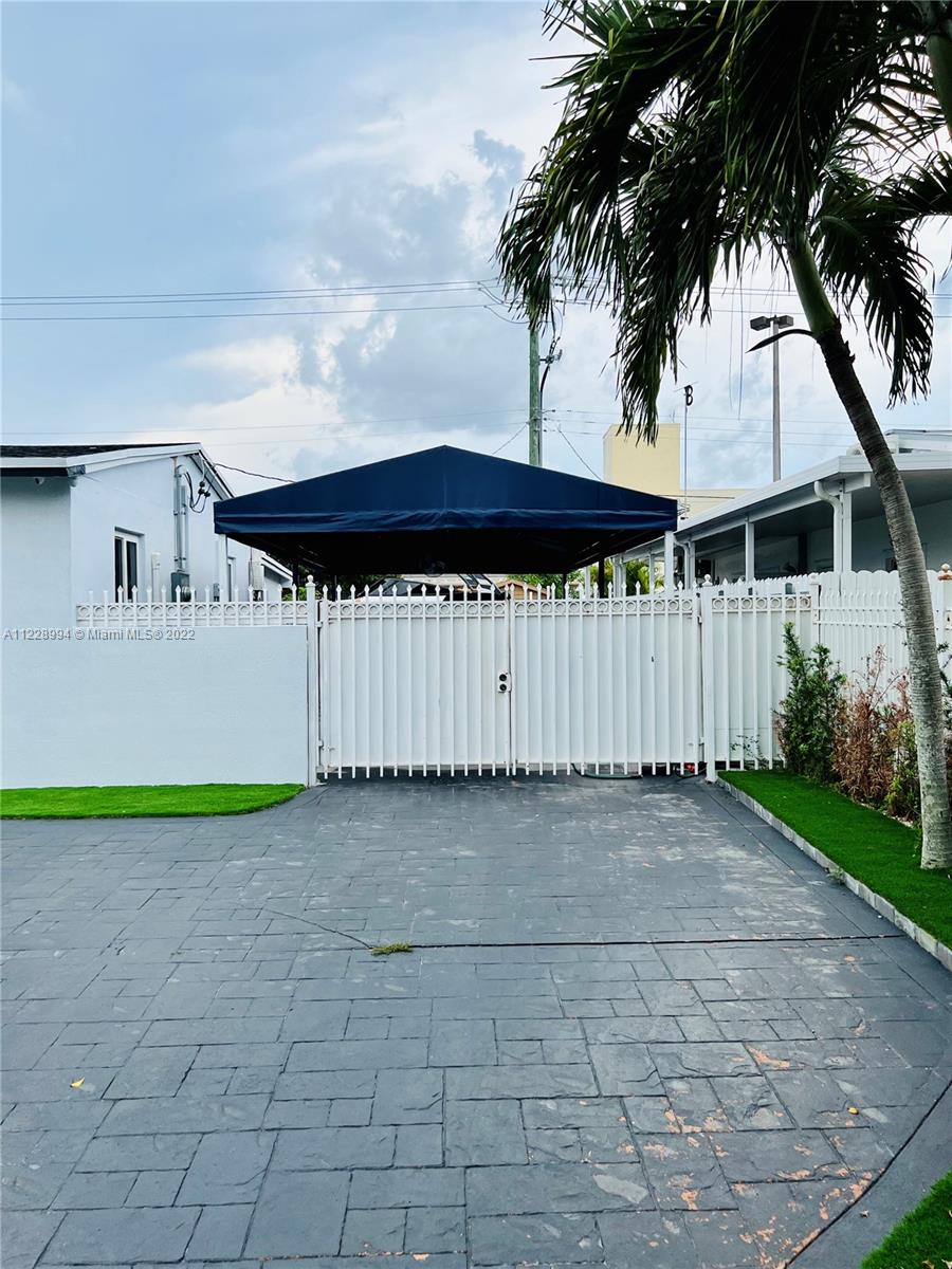 599 West 46th Place Hialeah, FL 33012 - Photo 4 of 25 a front view of a house with a garden