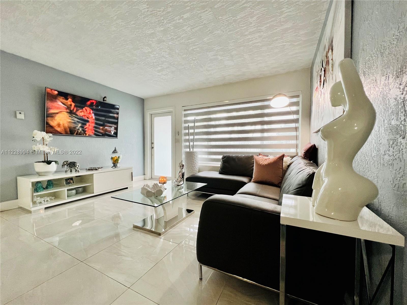 599 West 46th Place Hialeah, FL 33012 - Photo 5 of 25 a living room with furniture and a flat screen tv